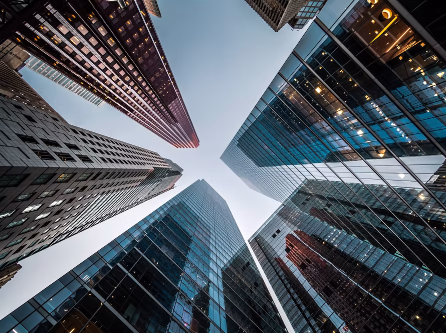 Looking up towards buildings in a business district.