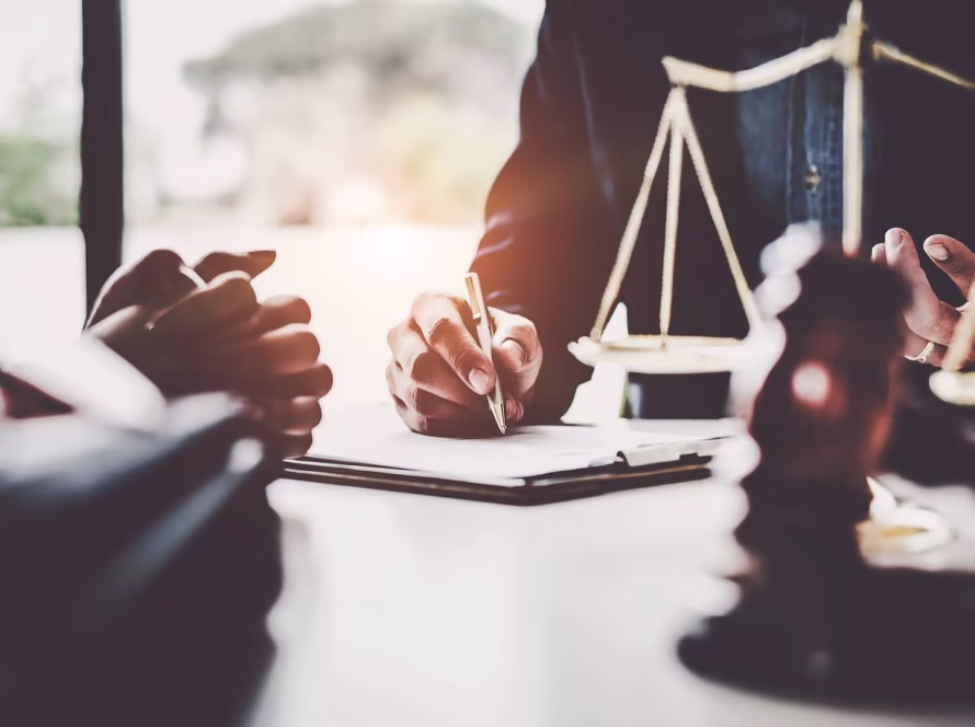 Legal professional writing on paperwork.